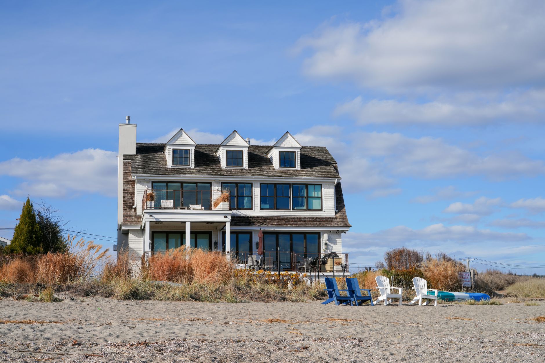 Charming beachfront house with patio chairs