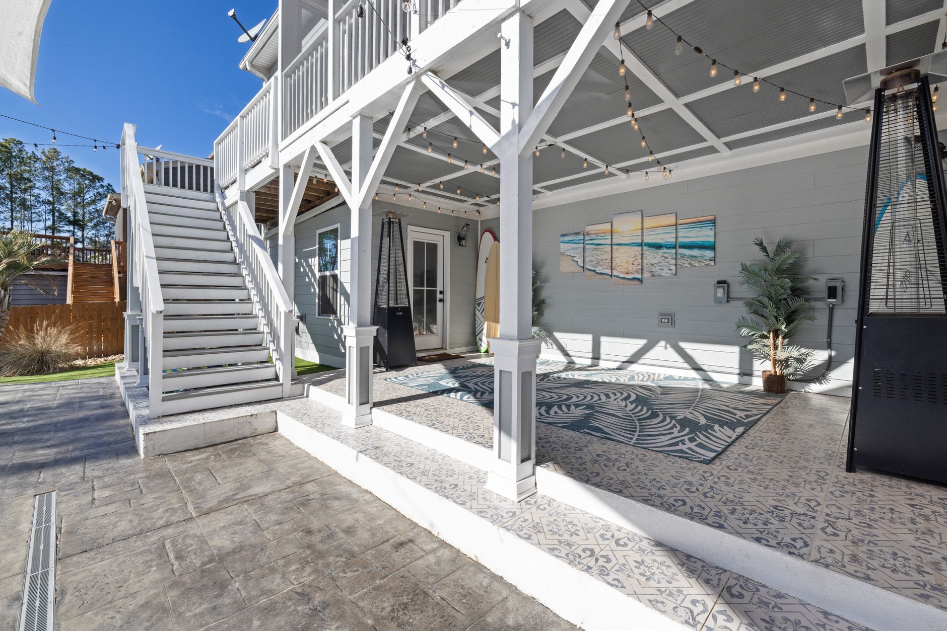 Modern coastal outdoor patio with lounge seating and surf-inspired decor